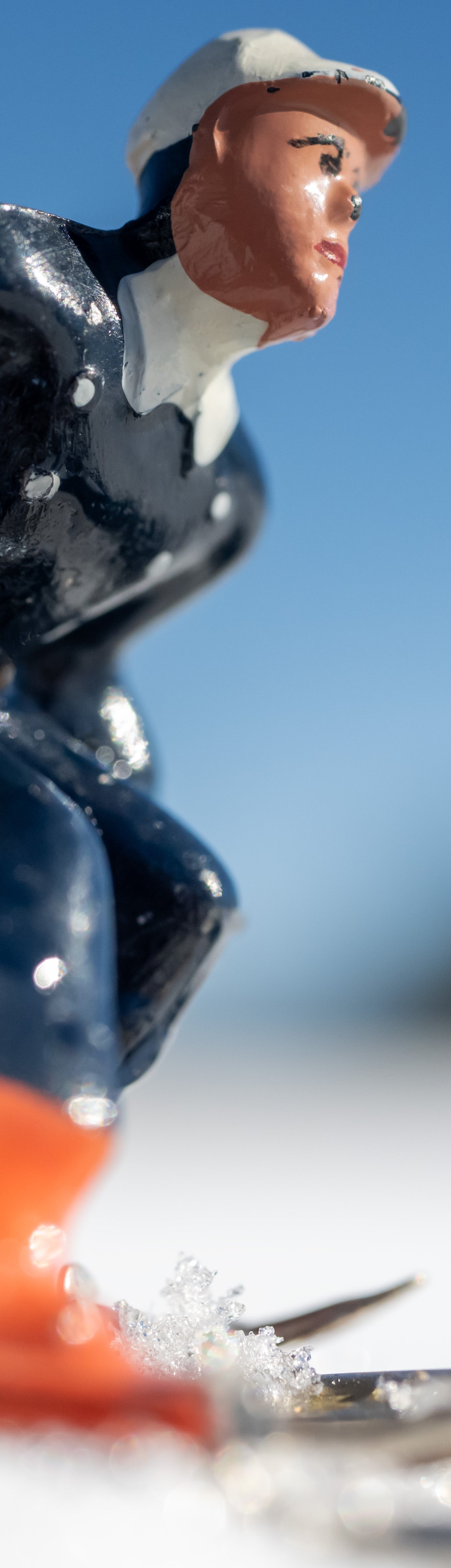 Detail shot of 40x50 image of three toy skiers by Hooey Mountain