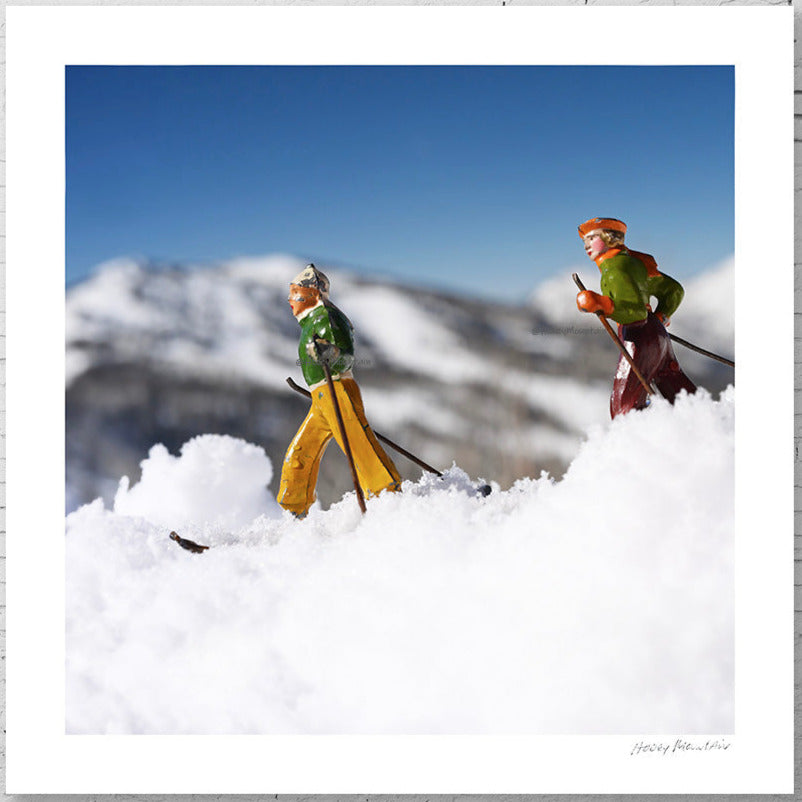 Antique toy skier couple  in the backcountry by Hooey Mountain
