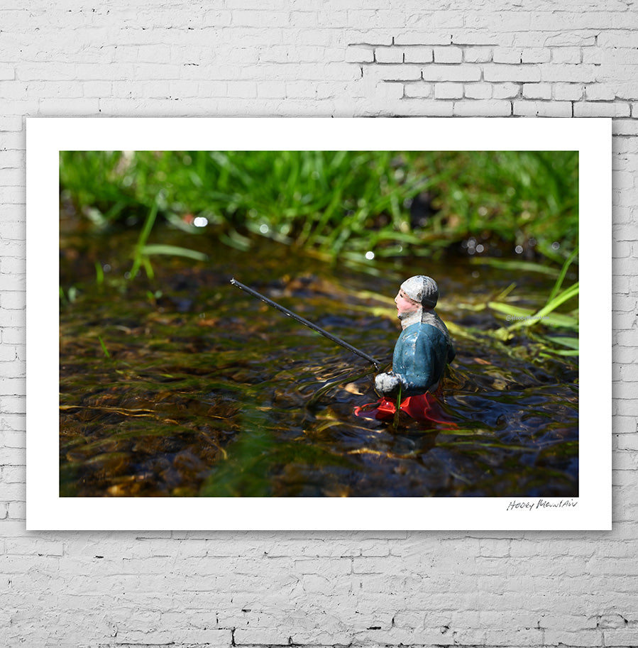 Vintage toy fisherman out getting the big one.