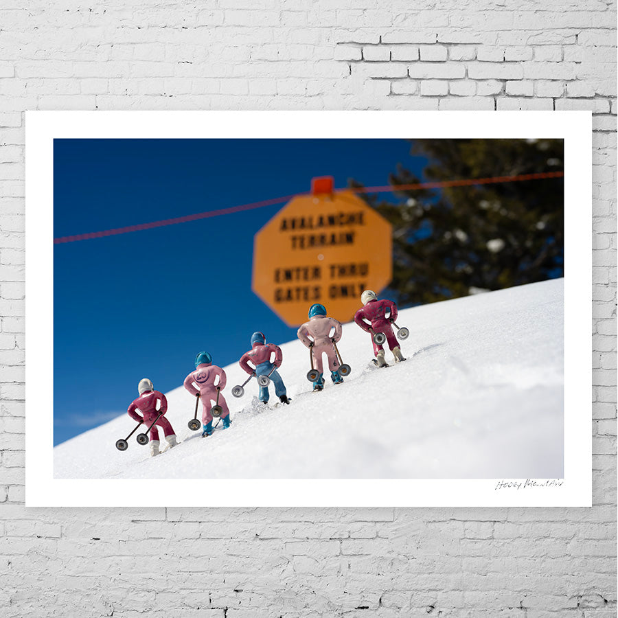 pink toy skiers near an avalanche sign by Hooey Mountain