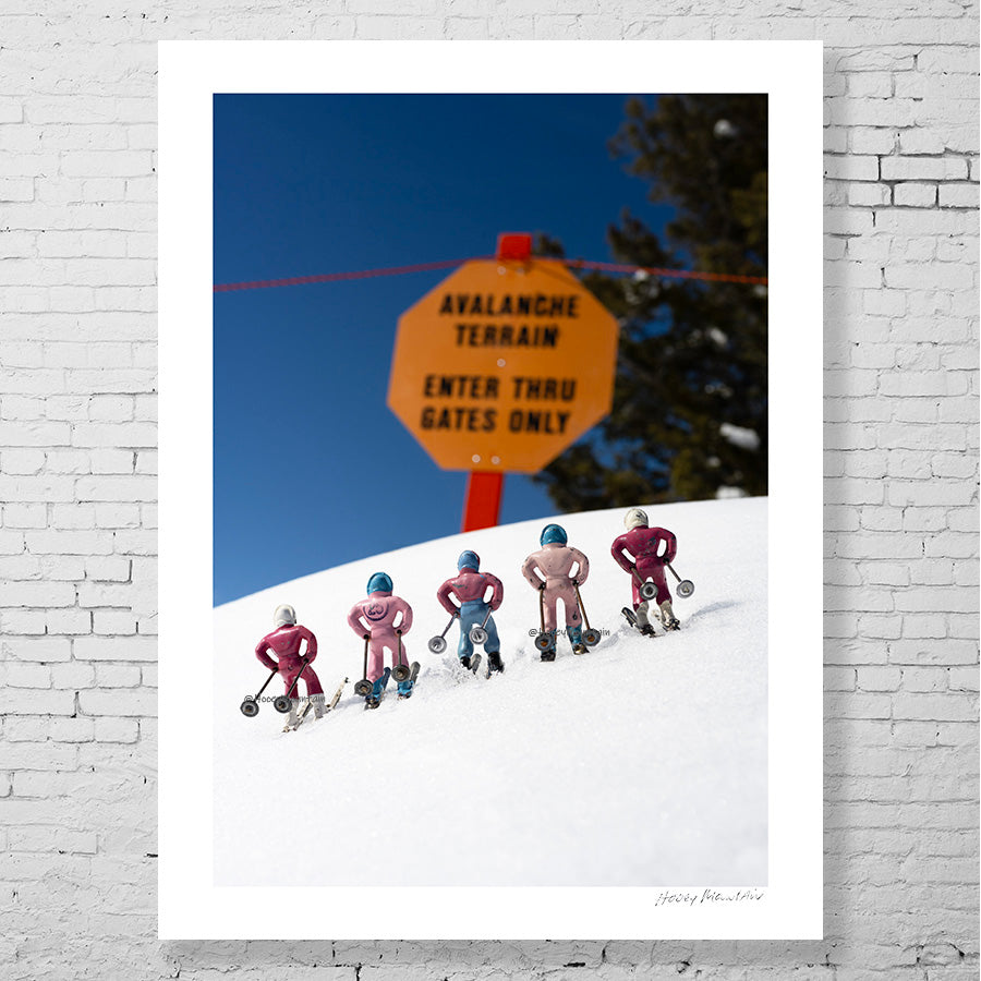 Ski Photography - Pink toy skiers viewing an avalanche sign by Hooey Mountain