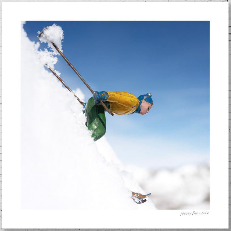 Toy skier racing down steep ski slope by Hooey Mountain