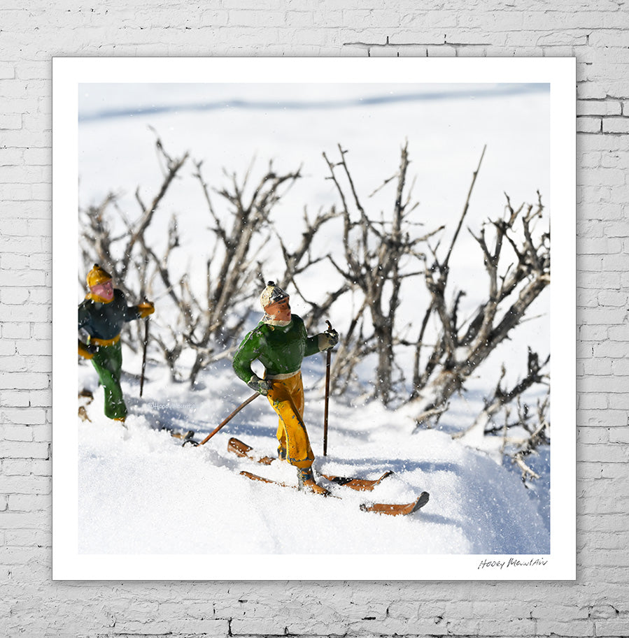 Small vintage toy skiers in a snow storm by Hooey Mountain