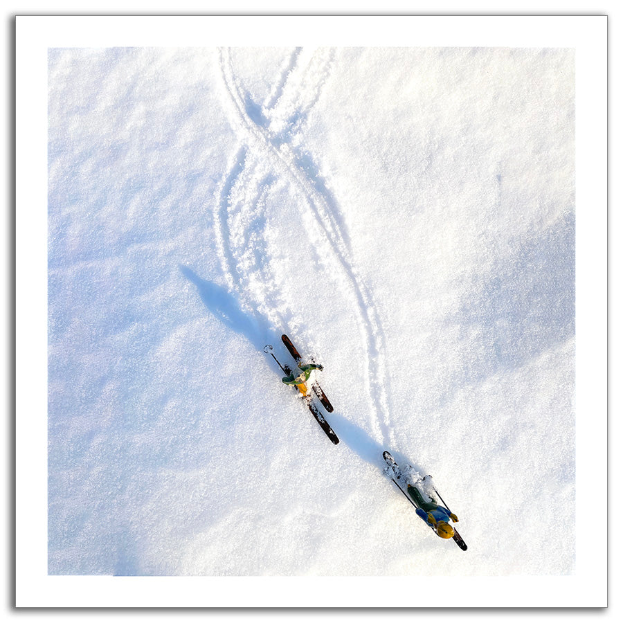 Two toy siers making figure 8s in powder