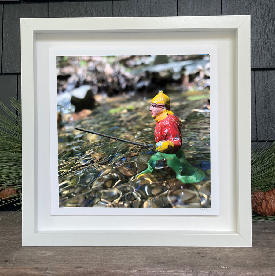 Antique toy fishing in a river by Hooey Mountain