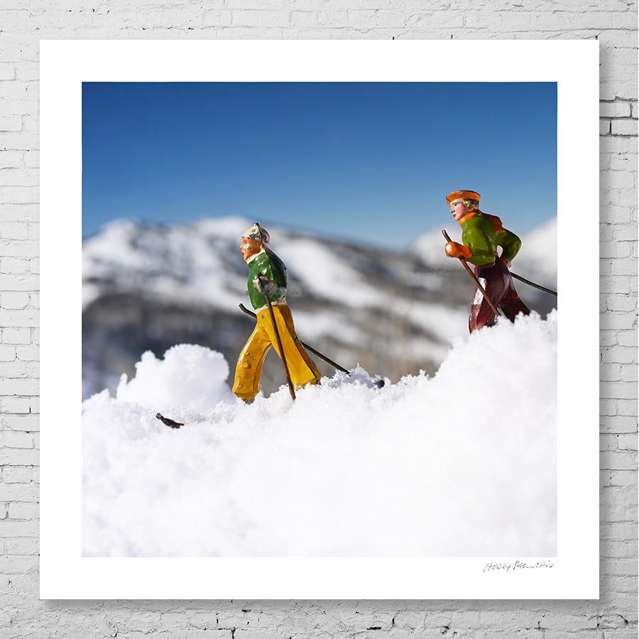 Antique toy skier couple  in the backcountry by Hooey Mountain