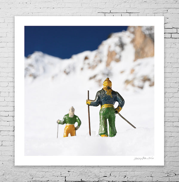 Two vintage toy skiers looking at the summit  by Hooey Mountain