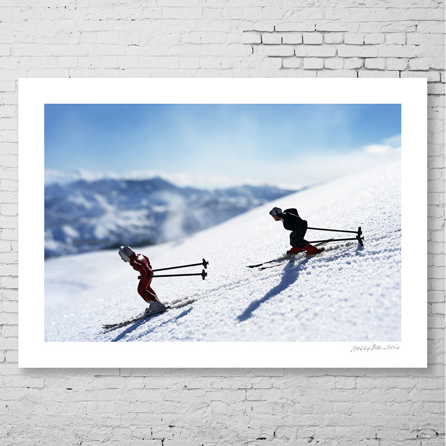 Antique toy skiers silhouetted at days end by Hooey Mountain