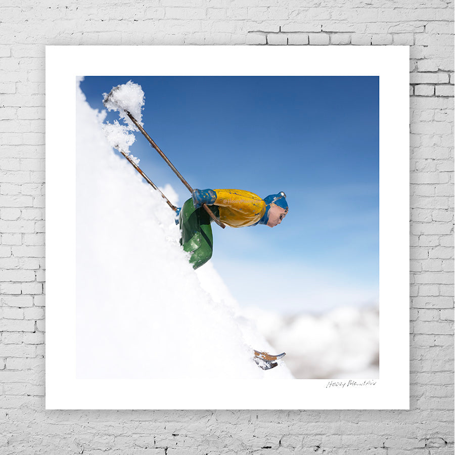Toy skier racing down steep ski slope by Hooey Mountain