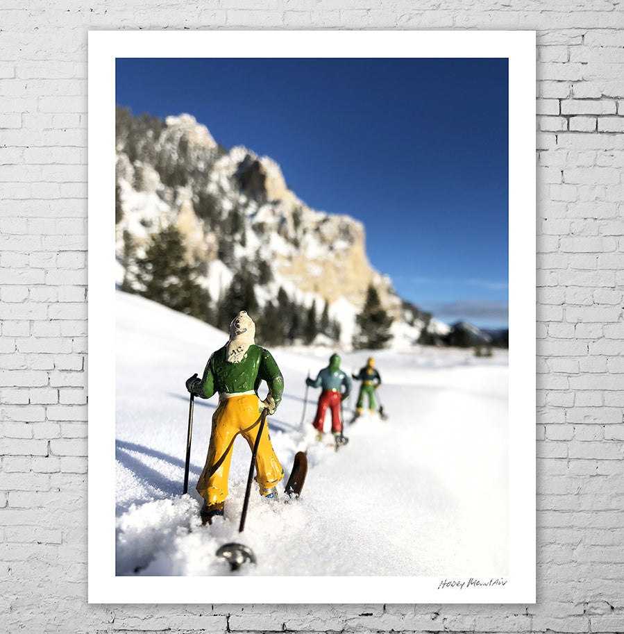 A trio of antique toy skiers by Hooey Mountain