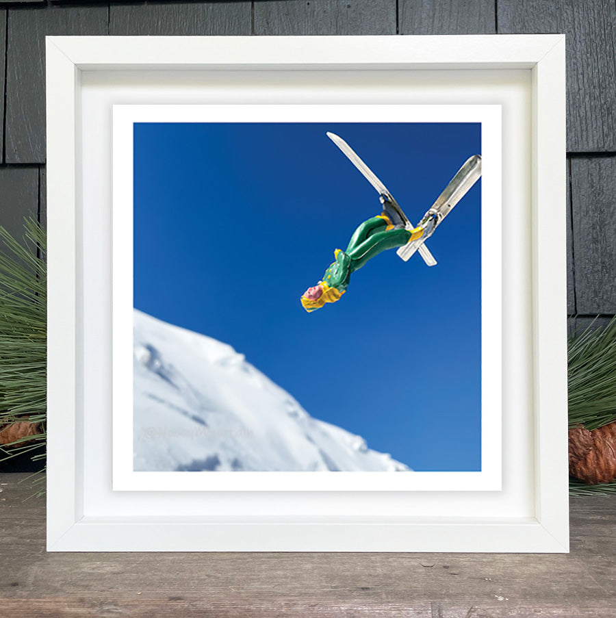 Toy skier jumping in air by Hooey Mountain