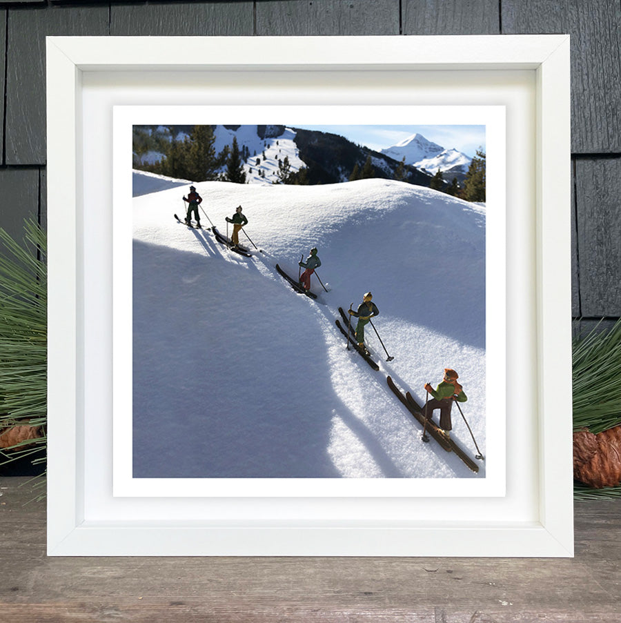 Vintage toy skiers climbing up the ski slope by Hooey Mountain