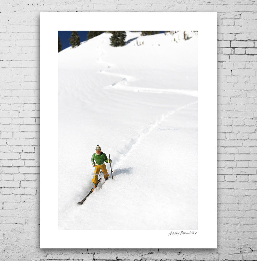 single toy skier in fresh powder by Hooey Mountain