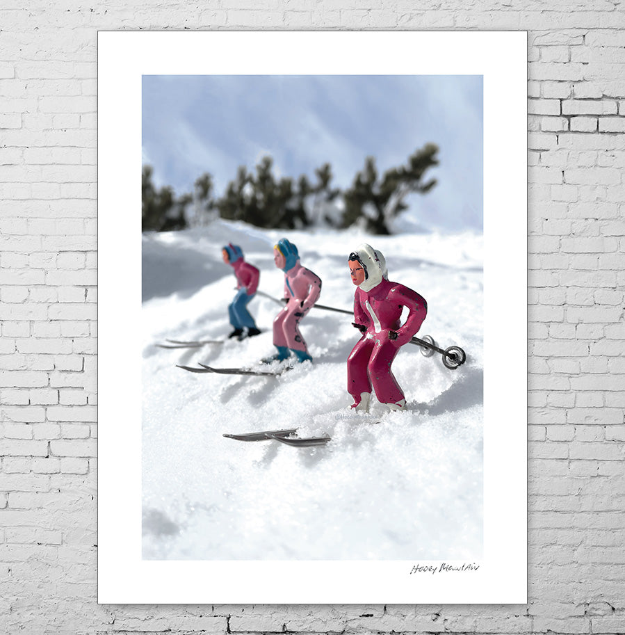 A trio of pink toy skiers by Hooey Mountain